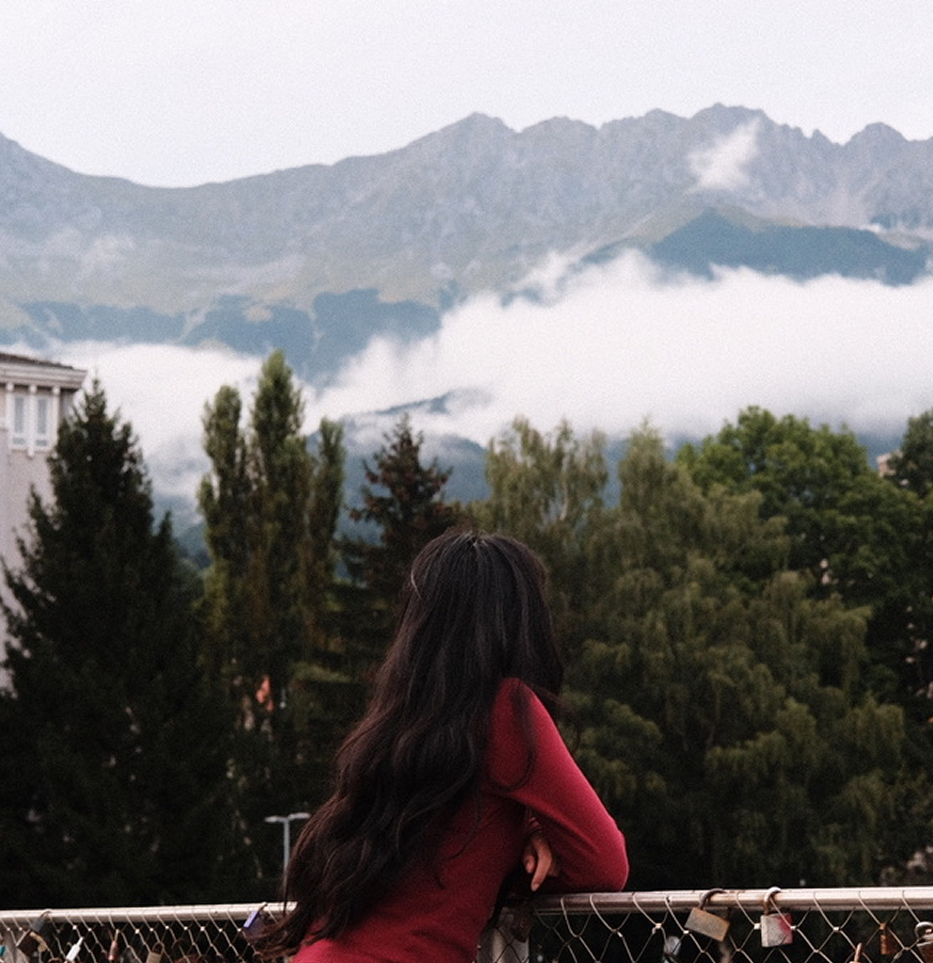 Mansi looking out over a mountain landscape