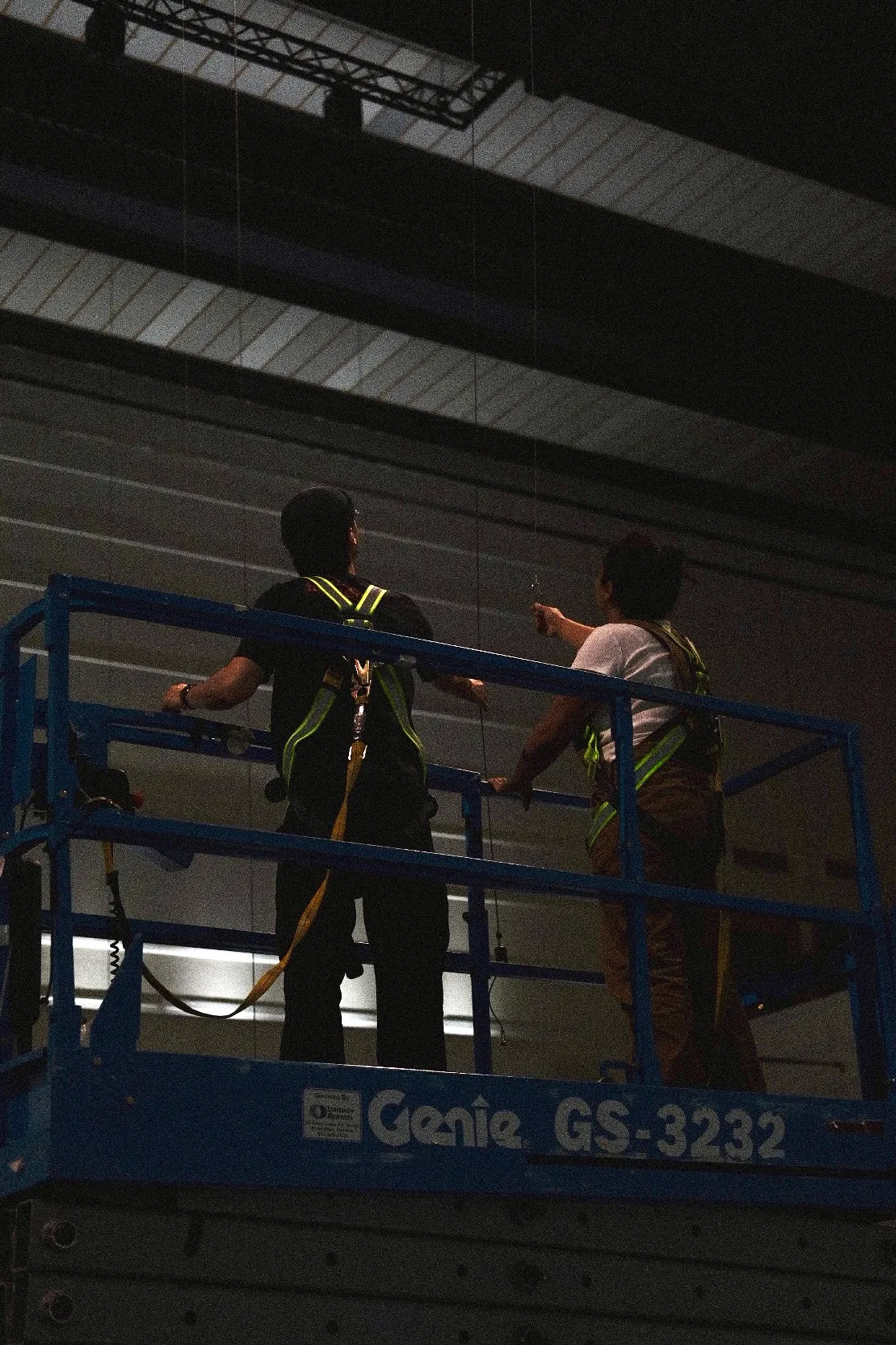 Two people on a lift during the installation